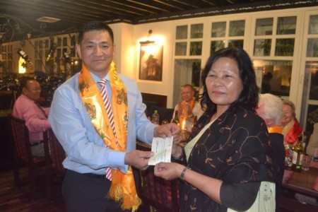 Mr Hari Gurung presenting cheque of Rs 50,000 on behalf of TDUK to Mrs Santu Ghale